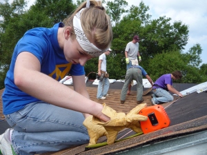 A student works on a roof at World Changers Biloxi, MS